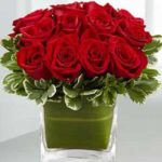 Glass vase of red roses